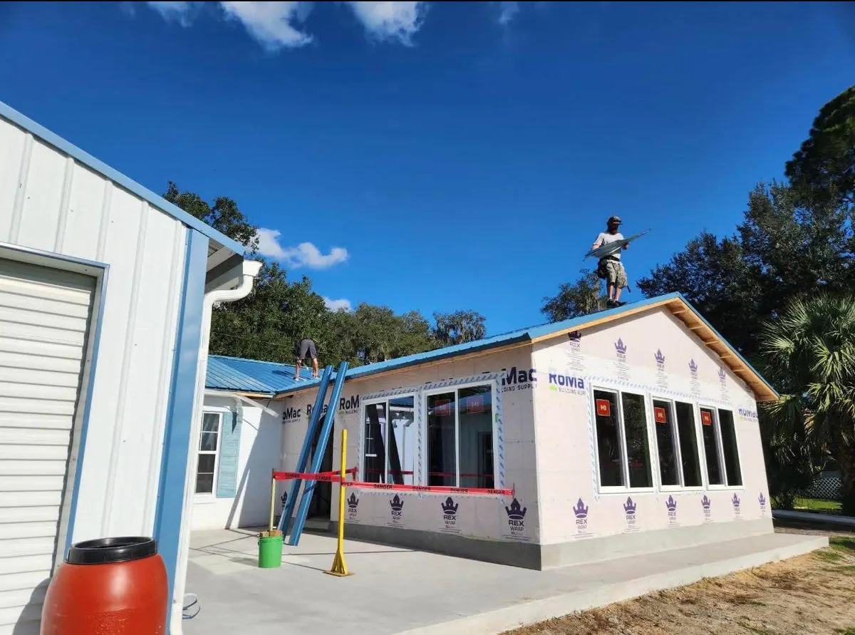 Destination Roofing crew installing a blue metal roof in Homosassa, Florida